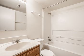 a bathroom with a sink and a tub and a toilet at Polo Run Apartments, Greenwood, Indiana